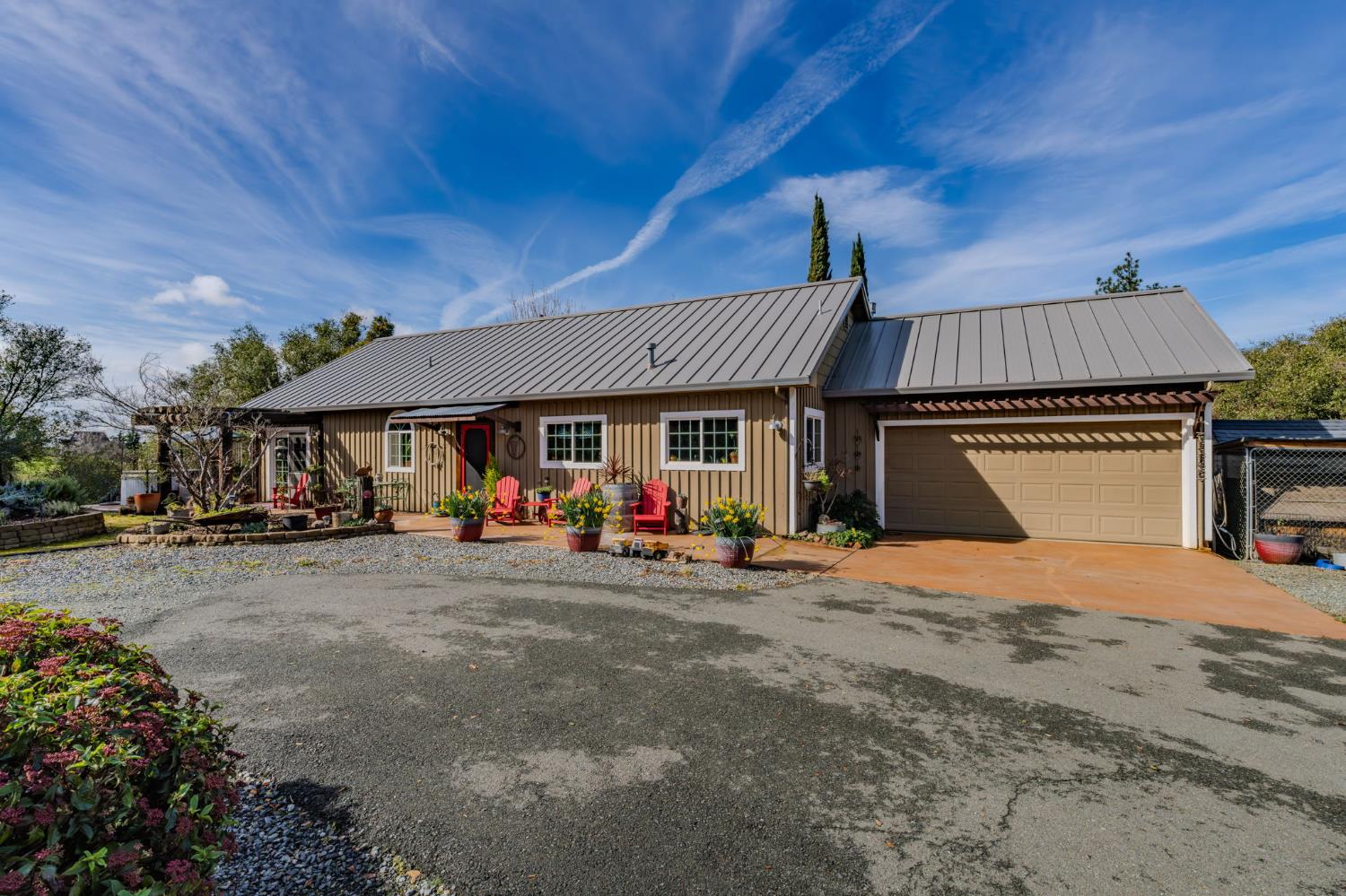 a view of a house with a patio and a yard