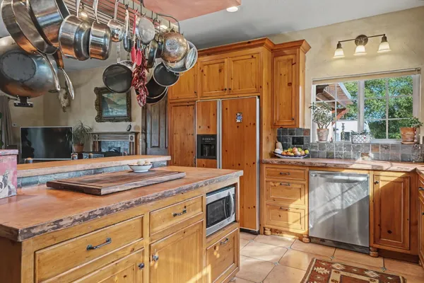 a kitchen with stainless steel appliances granite countertop a sink and cabinets