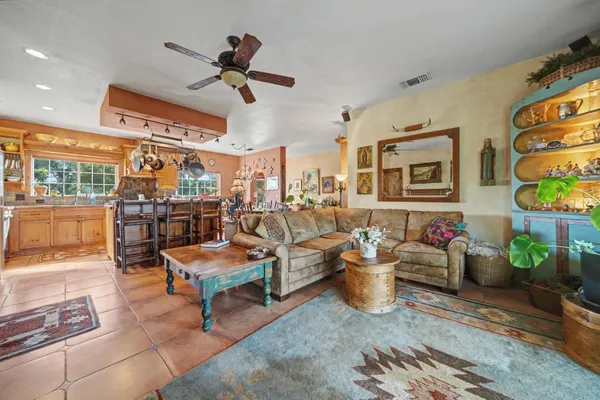 a living room with lots of furniture and a chandelier