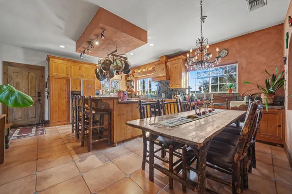 a view of a dining room with furniture and chandelier