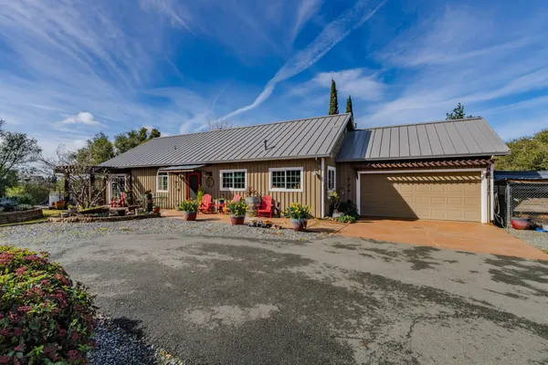 a view of a house with a patio and a yard