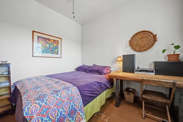 a bedroom with a bed and a desk