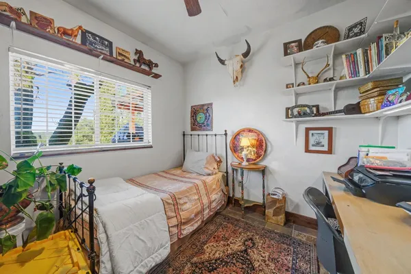 a bedroom with bed furniture and a window