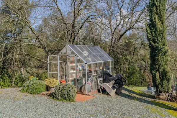 a view of a patio with table and chairs under an umbrella