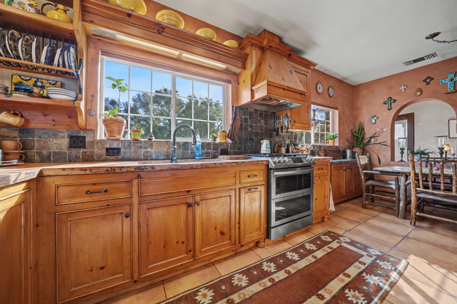 15900 Highway 88 Jackson, CA 95642 - Photo 7 of 48 a kitchen with stainless steel appliances granite countertop a stove a sink and a microwave