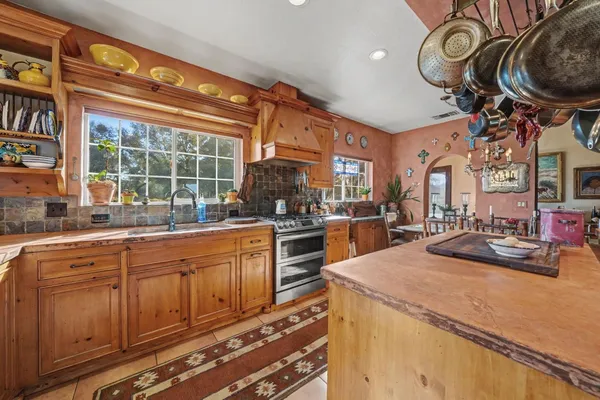 a kitchen with furniture a stove and a sink