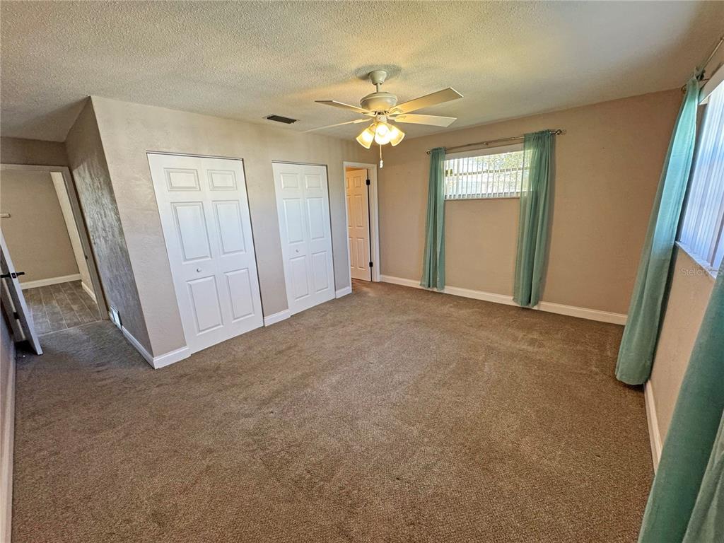 1421 Suwanee Road Daytona Beach, FL 32114 - Photo 13 of 21 an empty room with windows and closet