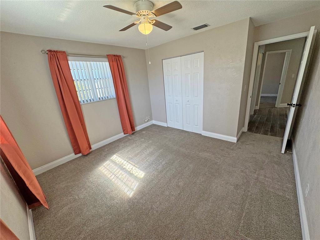 1421 Suwanee Road Daytona Beach, FL 32114 - Photo 15 of 21 an empty room with windows and fan