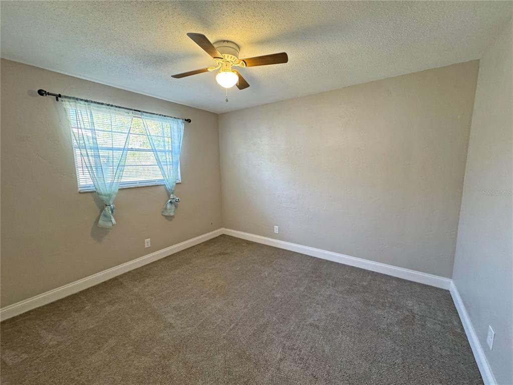 1421 Suwanee Road Daytona Beach, FL 32114 - Photo 16 of 21 an empty room with a window
