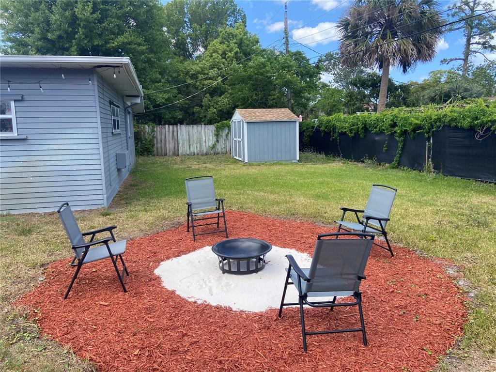 1421 Suwanee Road Daytona Beach, FL 32114 - Photo 18 of 21 a backyard of a house with table and chairs