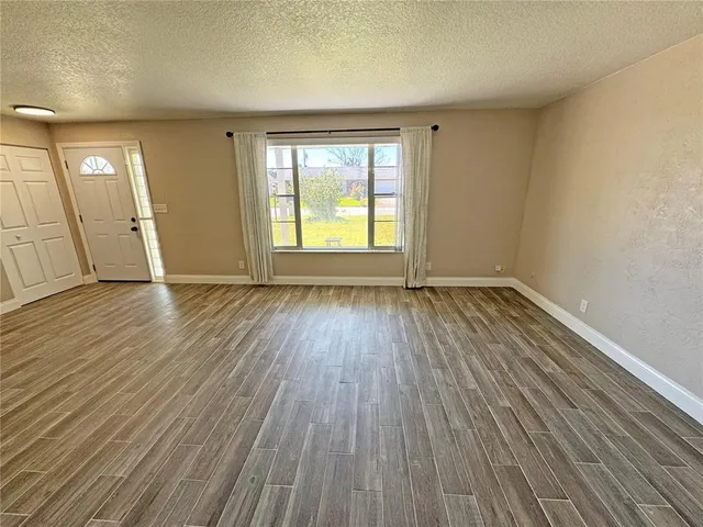 a view of a kitchen with a sink and wooden floor