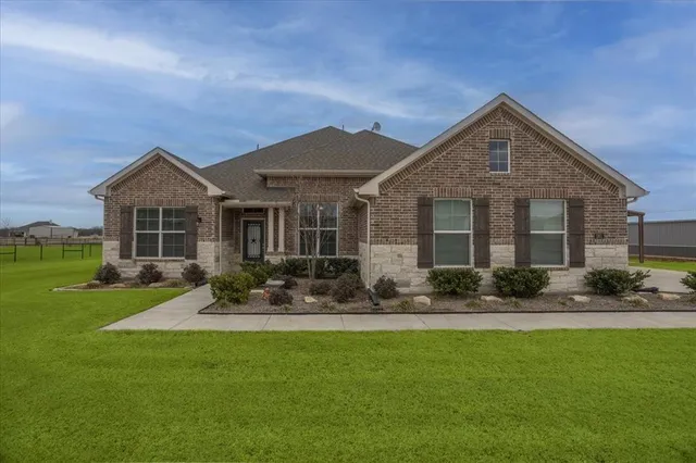 a front view of house with yard and green space