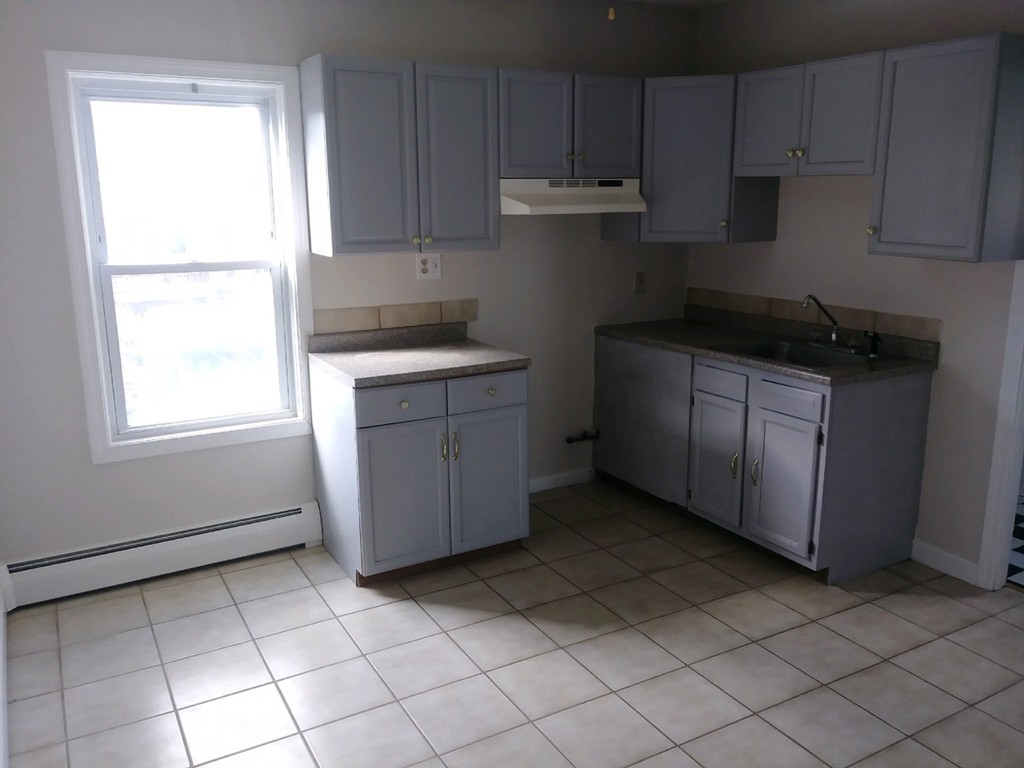141 Grant Street Fall River, MA 02721 - Photo 14 of 19 a kitchen with a cabinets and window