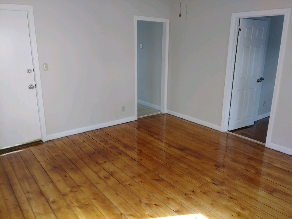 141 Grant Street Fall River, MA 02721 - Photo 8 of 19 a view of empty room with wooden floor