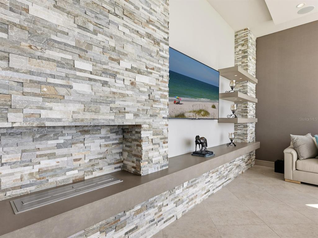 655 Longboat Club Road, Unit 1PH Longboat Key, FL 34228 - Photo 12 of 53 a room with furniture and a fireplace