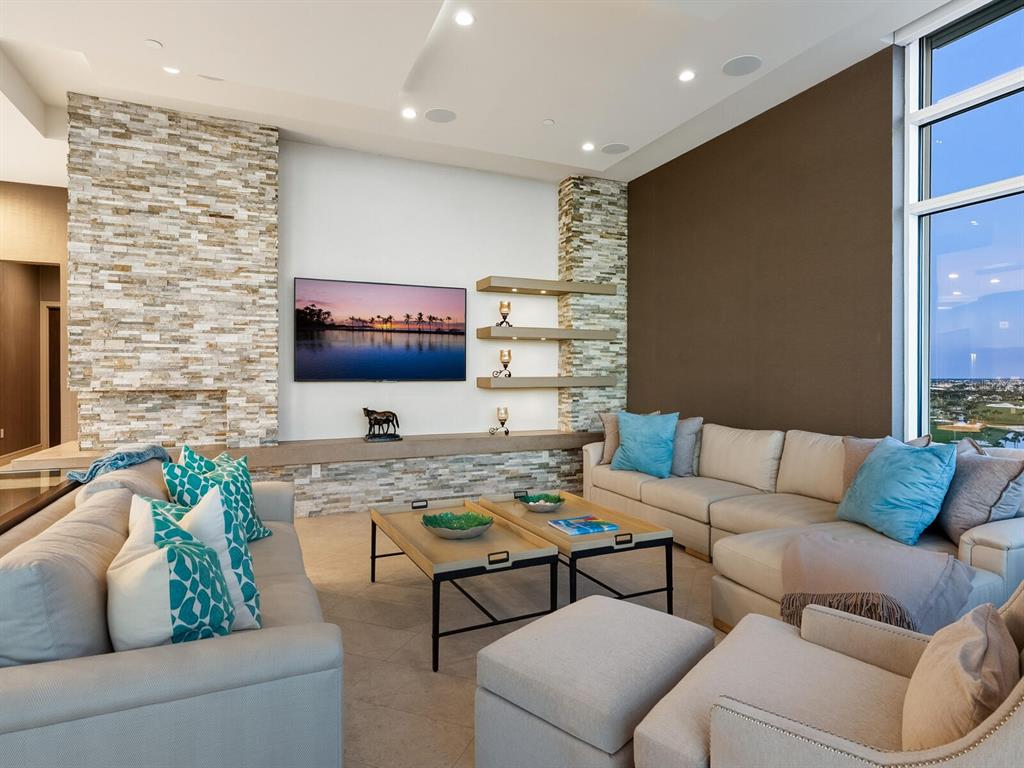 655 Longboat Club Road, Unit 1PH Longboat Key, FL 34228 - Photo 15 of 53 a living room with furniture and a flat screen tv