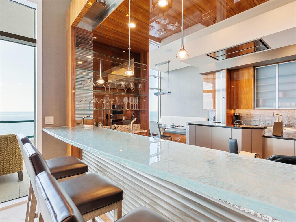 655 Longboat Club Road, Unit 1PH Longboat Key, FL 34228 - Photo 24 of 53 a large kitchen with stainless steel appliances kitchen island granite countertop a large window and a counter space