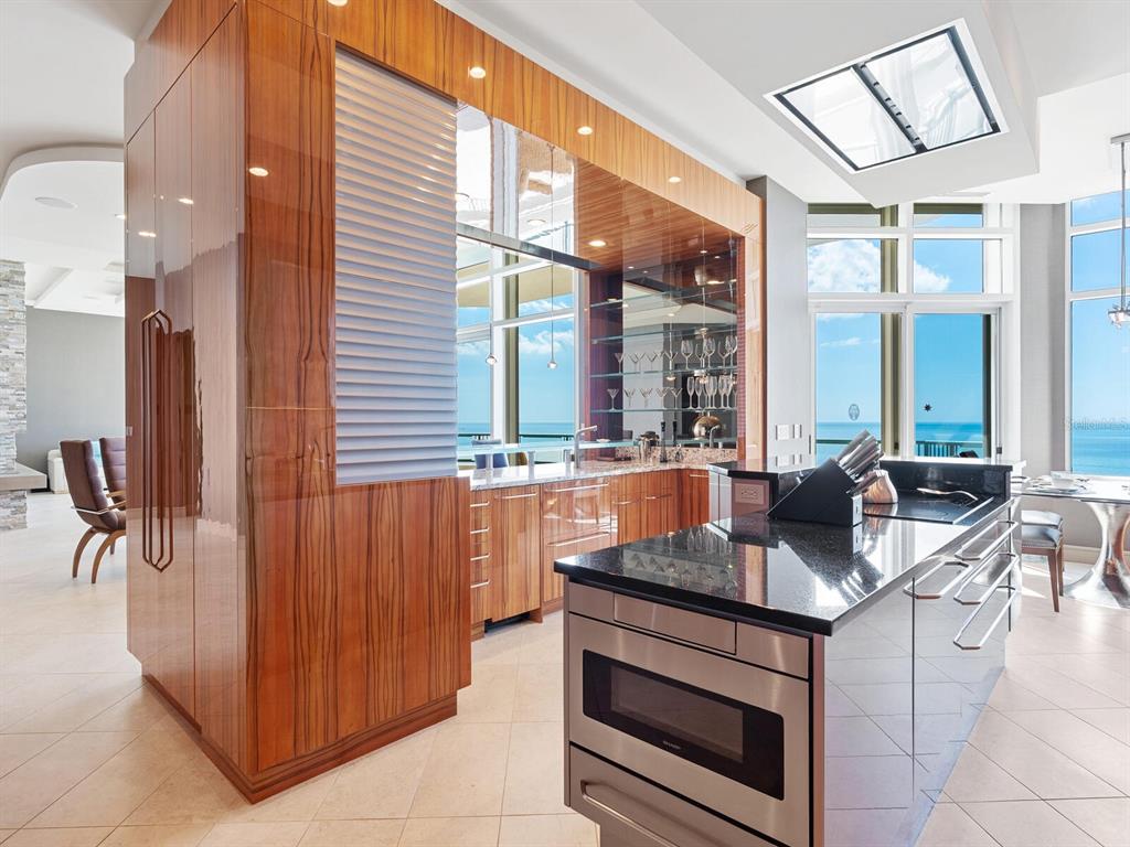 655 Longboat Club Road, Unit 1PH Longboat Key, FL 34228 - Photo 25 of 53 a kitchen with stainless steel appliances granite countertop a stove and a sink