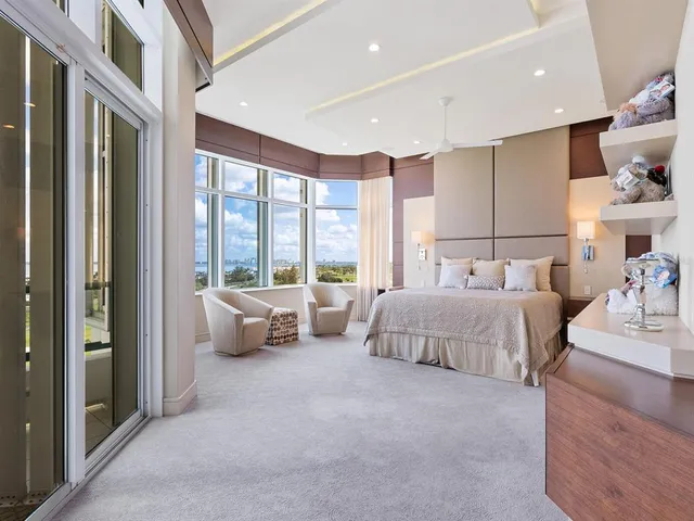 a living room with couch and a floor to ceiling window