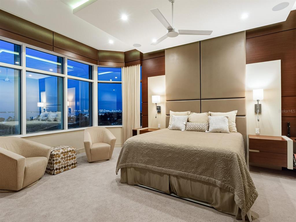 655 Longboat Club Road, Unit 1PH Longboat Key, FL 34228 - Photo 32 of 53 a bedroom with a large bed and a couch