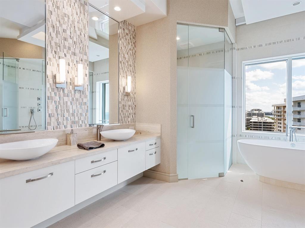 655 Longboat Club Road, Unit 1PH Longboat Key, FL 34228 - Photo 36 of 53 a bathroom with double vanity sink a mirror and a shower