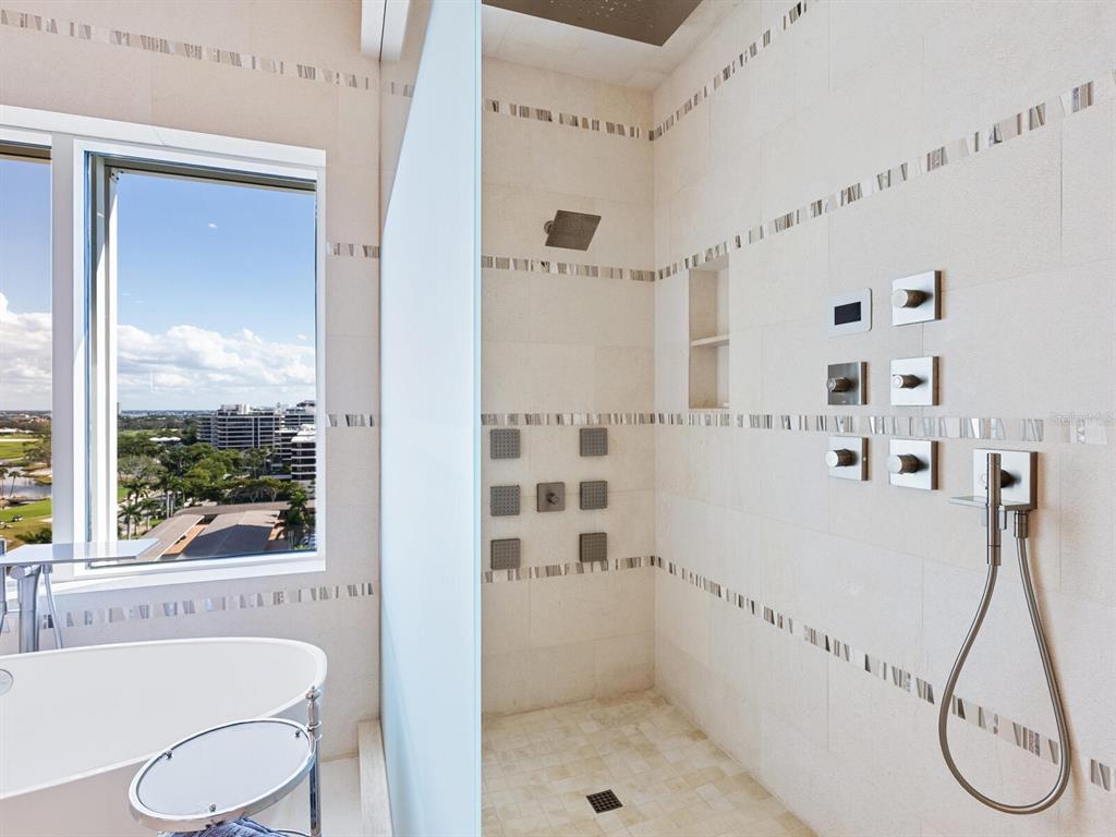 655 Longboat Club Road, Unit 1PH Longboat Key, FL 34228 - Photo 38 of 53 a bathroom with a tub a sink and a shower