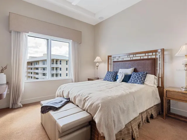 a bedroom with a bed and glass window