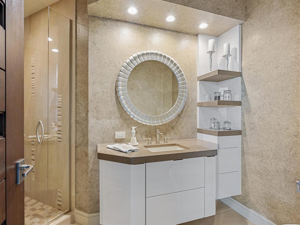 655 Longboat Club Road, Unit 1PH Longboat Key, FL 34228 - Photo 43 of 53 a bathroom with a sink and a mirror
