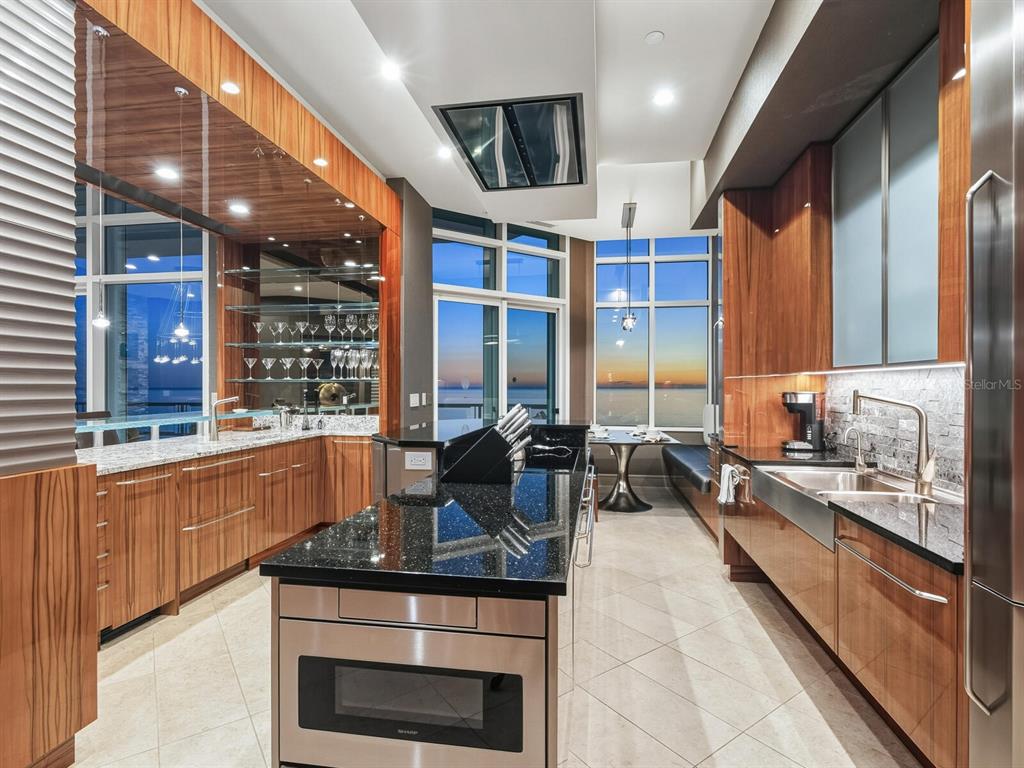 655 Longboat Club Road, Unit 1PH Longboat Key, FL 34228 - Photo 6 of 53 a kitchen with stainless steel appliances granite countertop a stove a sink and a refrigerator