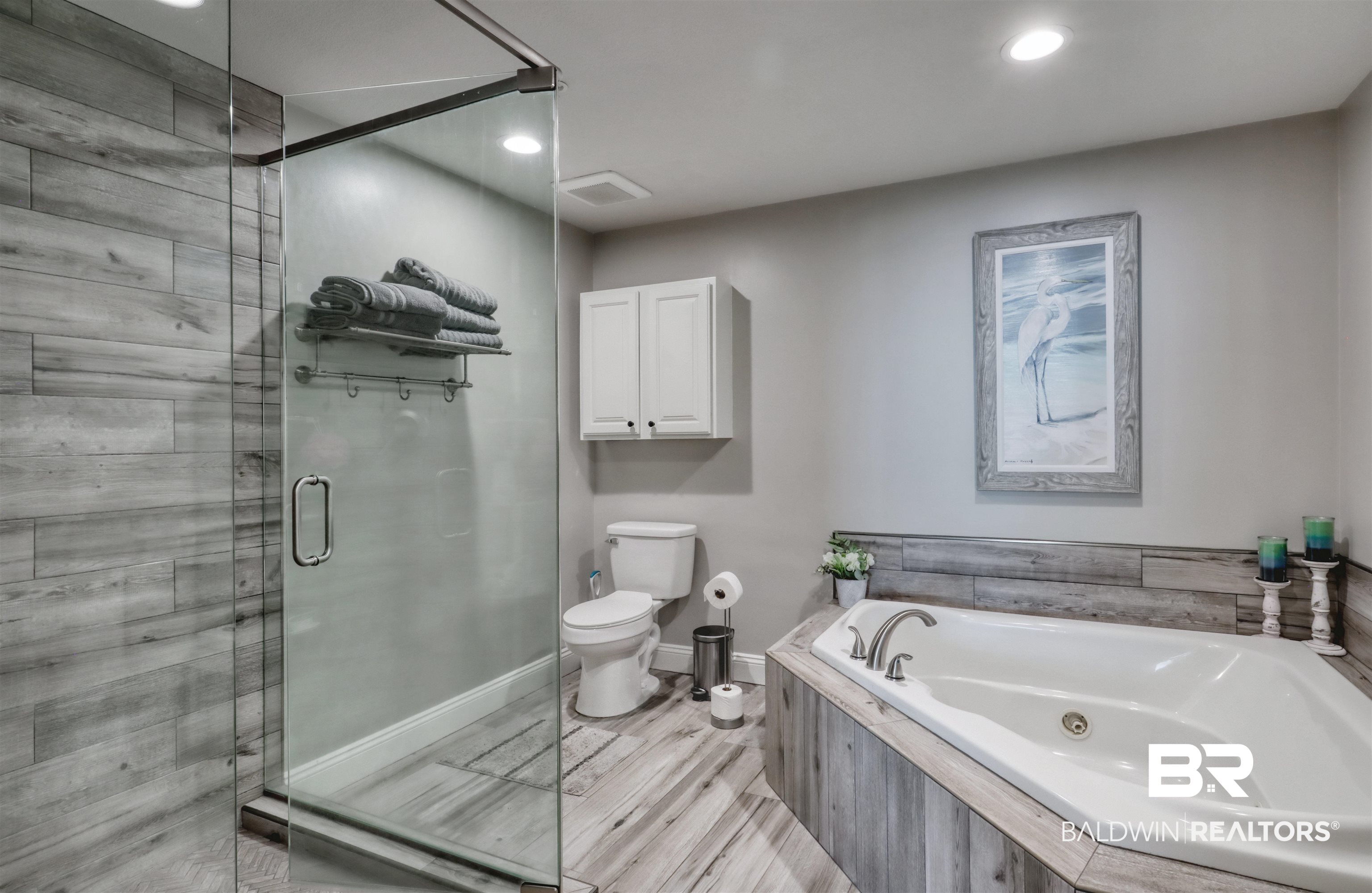 27800 Canal Road, Unit 403 & 404 Orange Beach, AL 36561 - Photo 12 of 39 Primary Bathroom featuring separate tiled shower and tub and toilet.