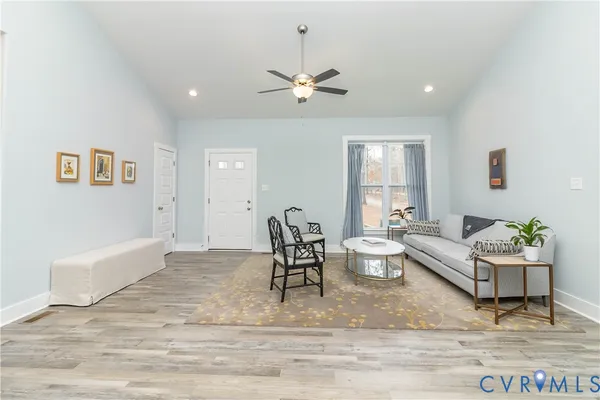 a living room with furniture and a chandelier