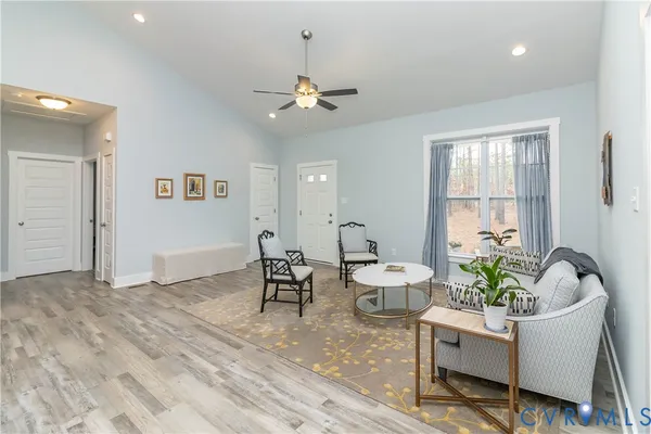 a living room with furniture a window and a chandelier