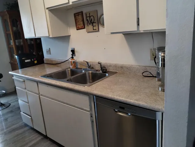 a kitchen with a sink and cabinets