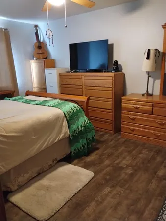 a bedroom with a bed and a flat screen tv
