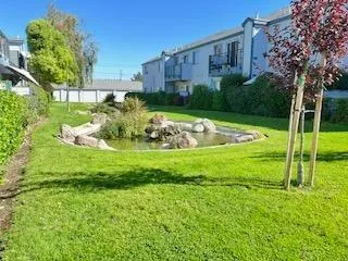a view of a house with a yard and a fountain