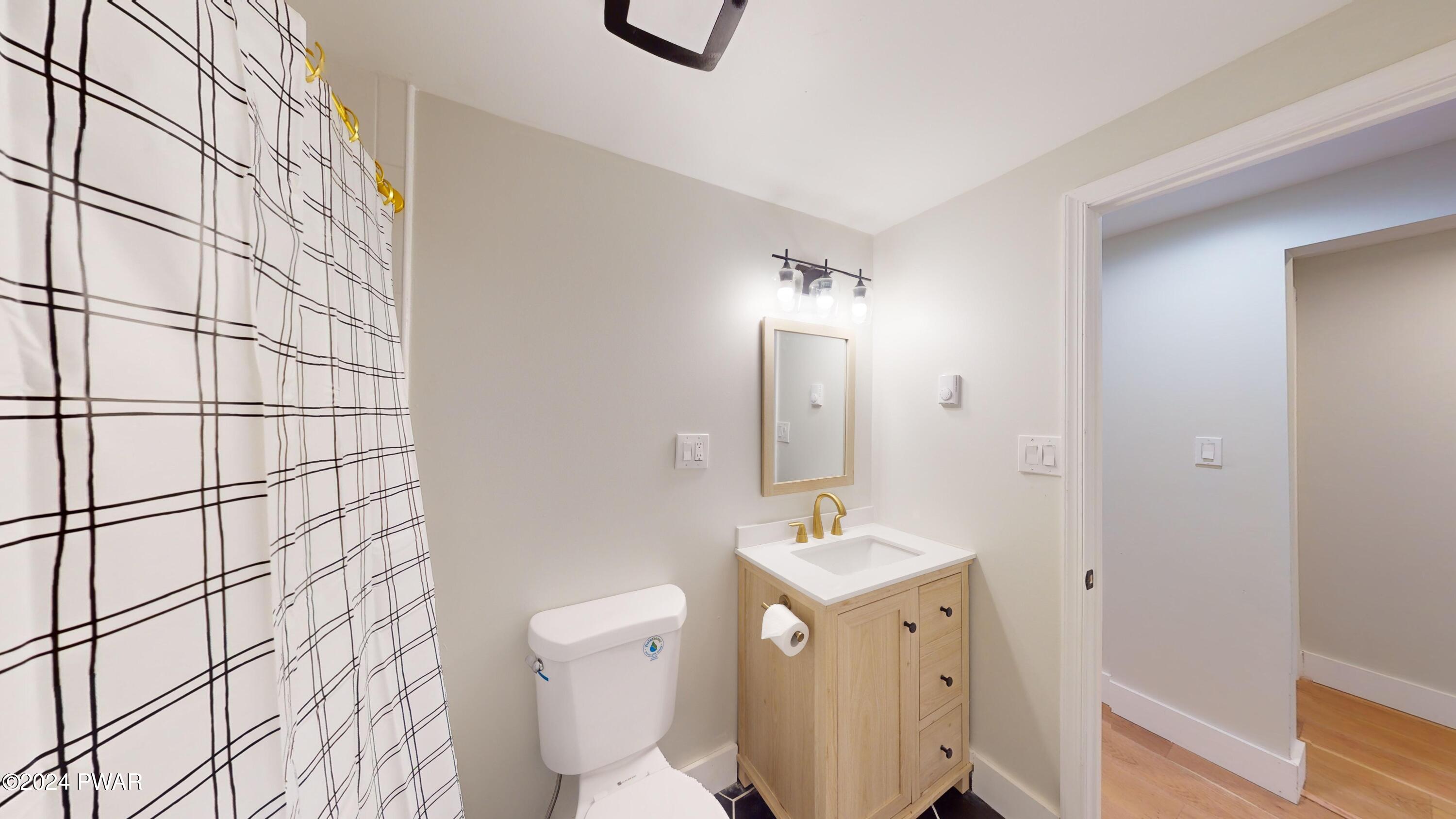 107 Hickory Road Milford, PA 18337 - Photo 34 of 39 a bathroom with a toilet sink and mirror