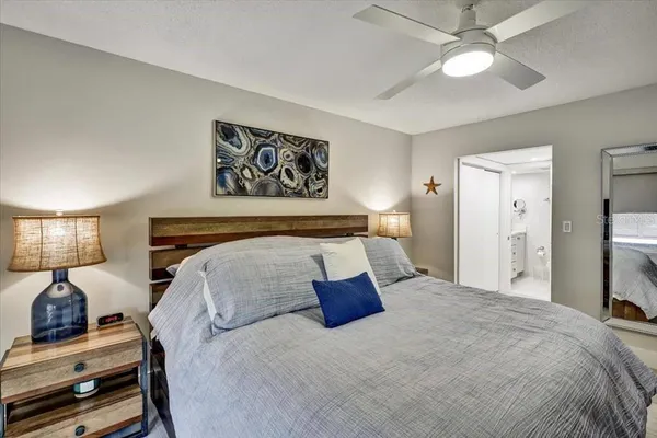 a bedroom with bed and wooden floor