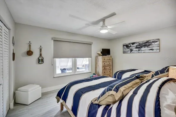 a bedroom with a bed couches and window