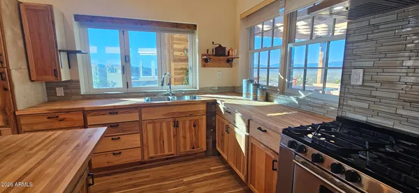 a kitchen that has a sink and a stove