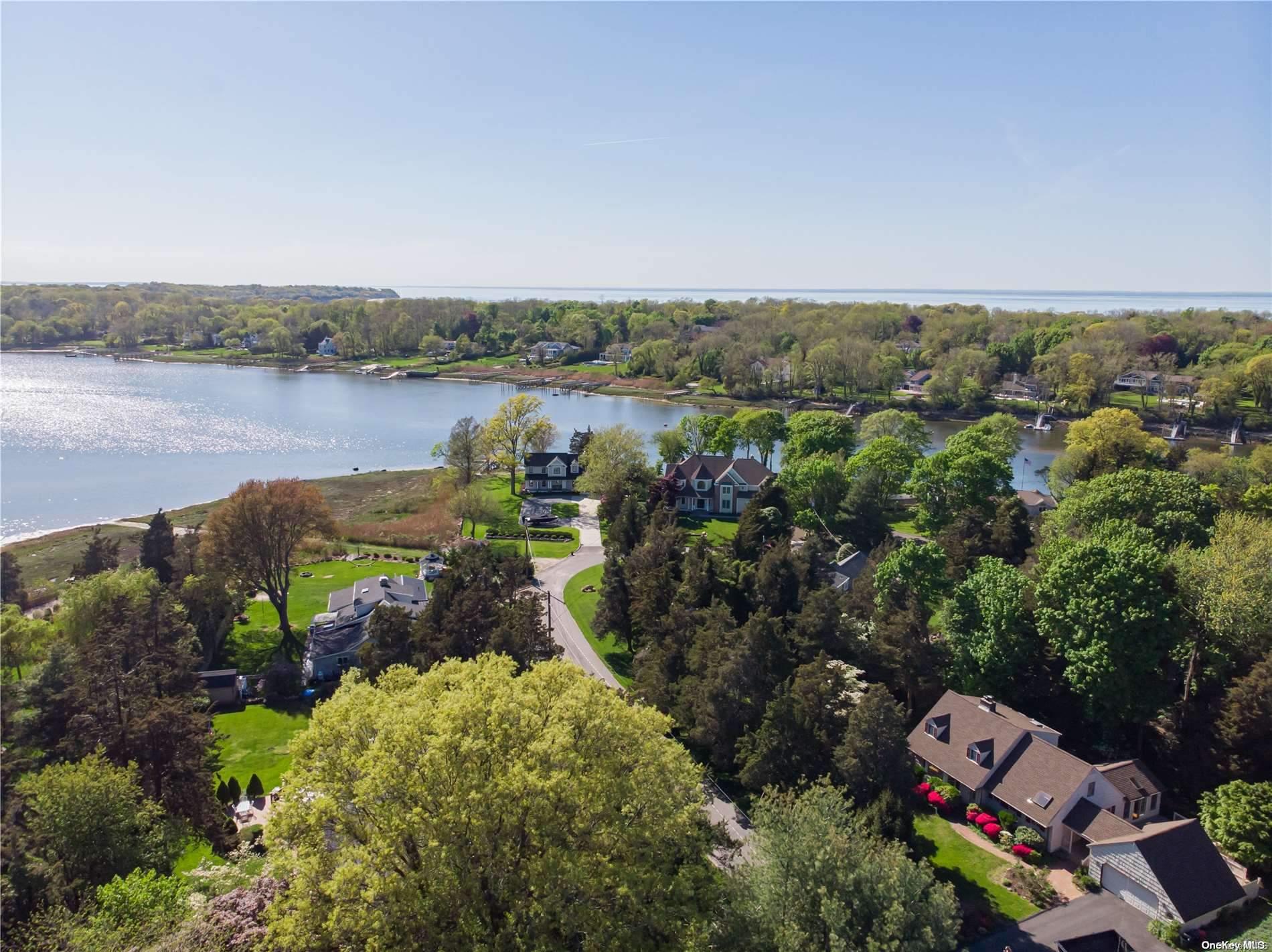9 Cedar Lane Setauket, NY 11733 - Photo 1 of 1 an aerial view of a house with a garden and lake view