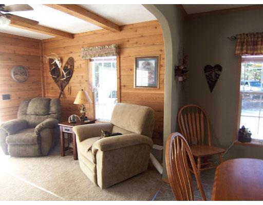 8 Berry Pit Road Hudson, ME 04449 - Photo 9 of 24 Living Room. Warm panelling in...