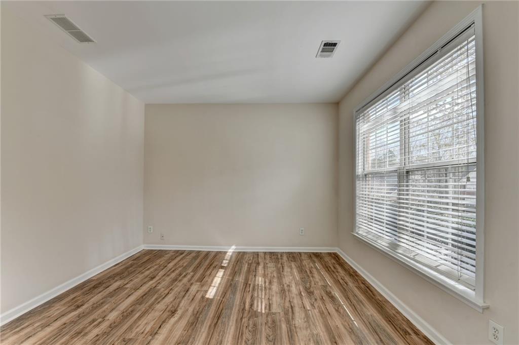 100 Hawnley Trc Northwest Suwanee, GA 30024 - Photo 10 of 58 a view of a room with wooden floor and a window