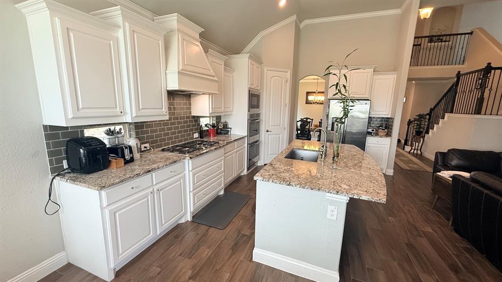 337 Prairie Ridge Lane Lewisville, TX 75056 - Photo 6 of 28 a kitchen with granite countertop a sink a counter top space and cabinets