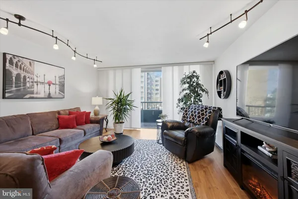 a living room with furniture rug and wooden floor