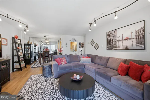 a living room with furniture and wooden floor