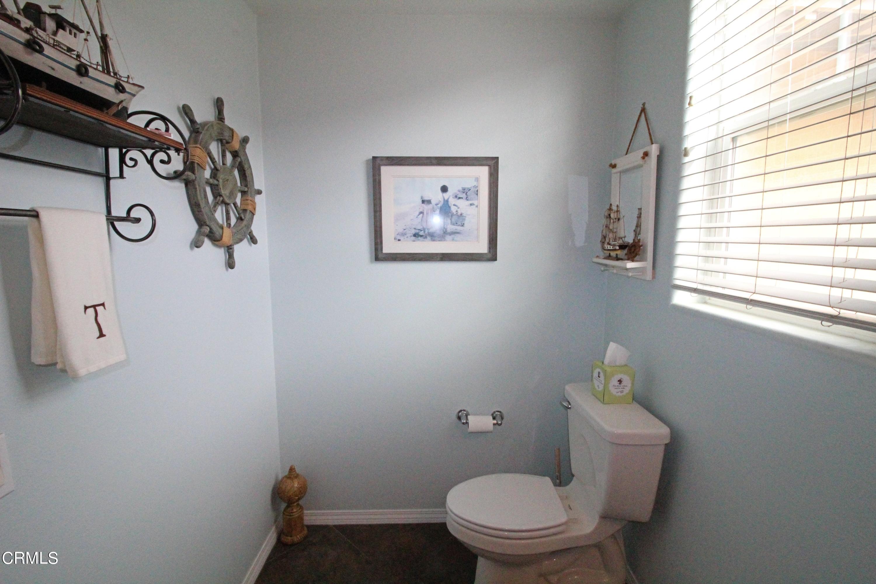 1428 Windshore Way Oxnard, CA 93035 - Photo 18 of 29 a white toilet sitting next to a window and a small bathroom