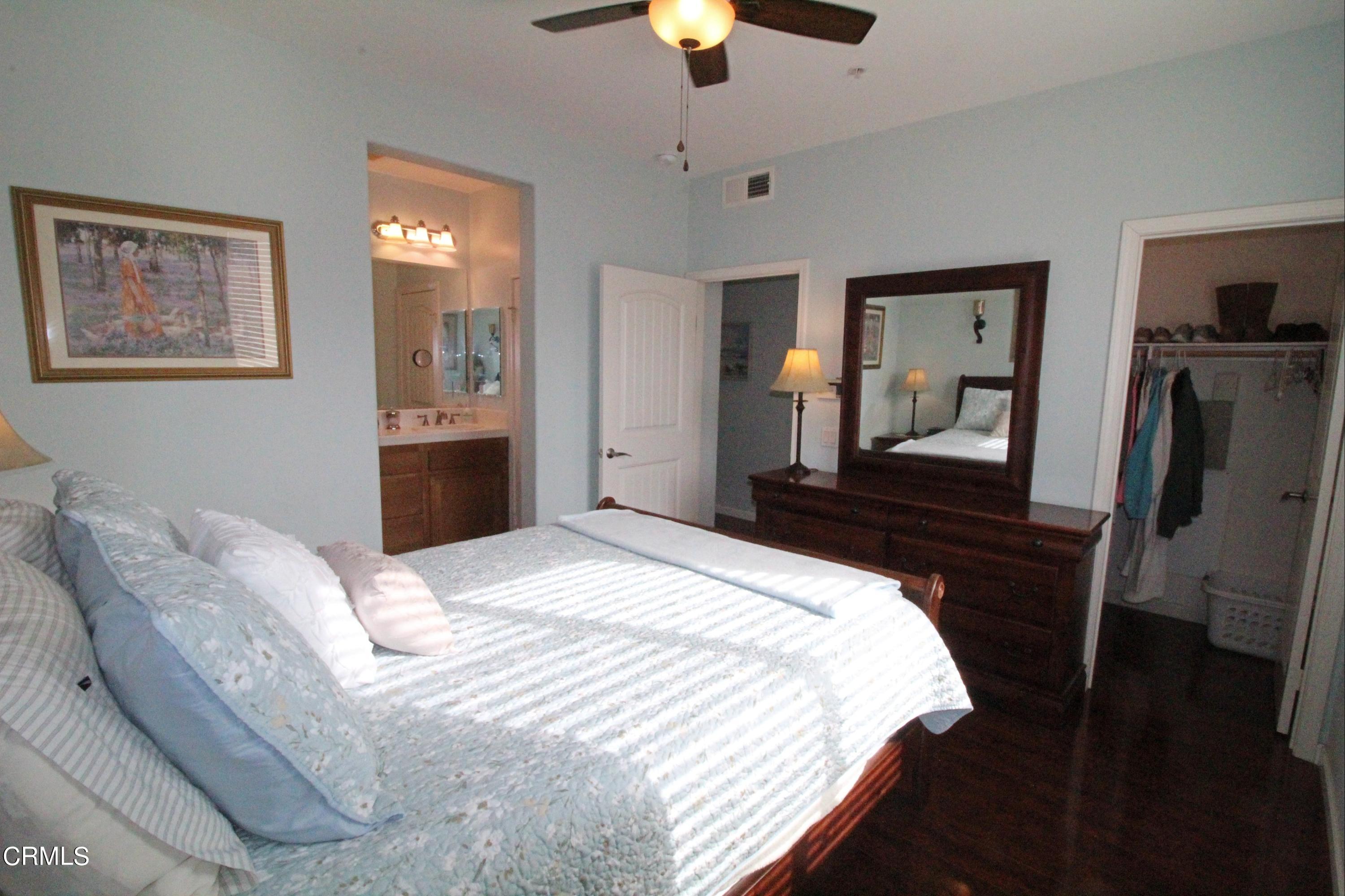 1428 Windshore Way Oxnard, CA 93035 - Photo 20 of 29 a bedroom with a bed and a chandelier