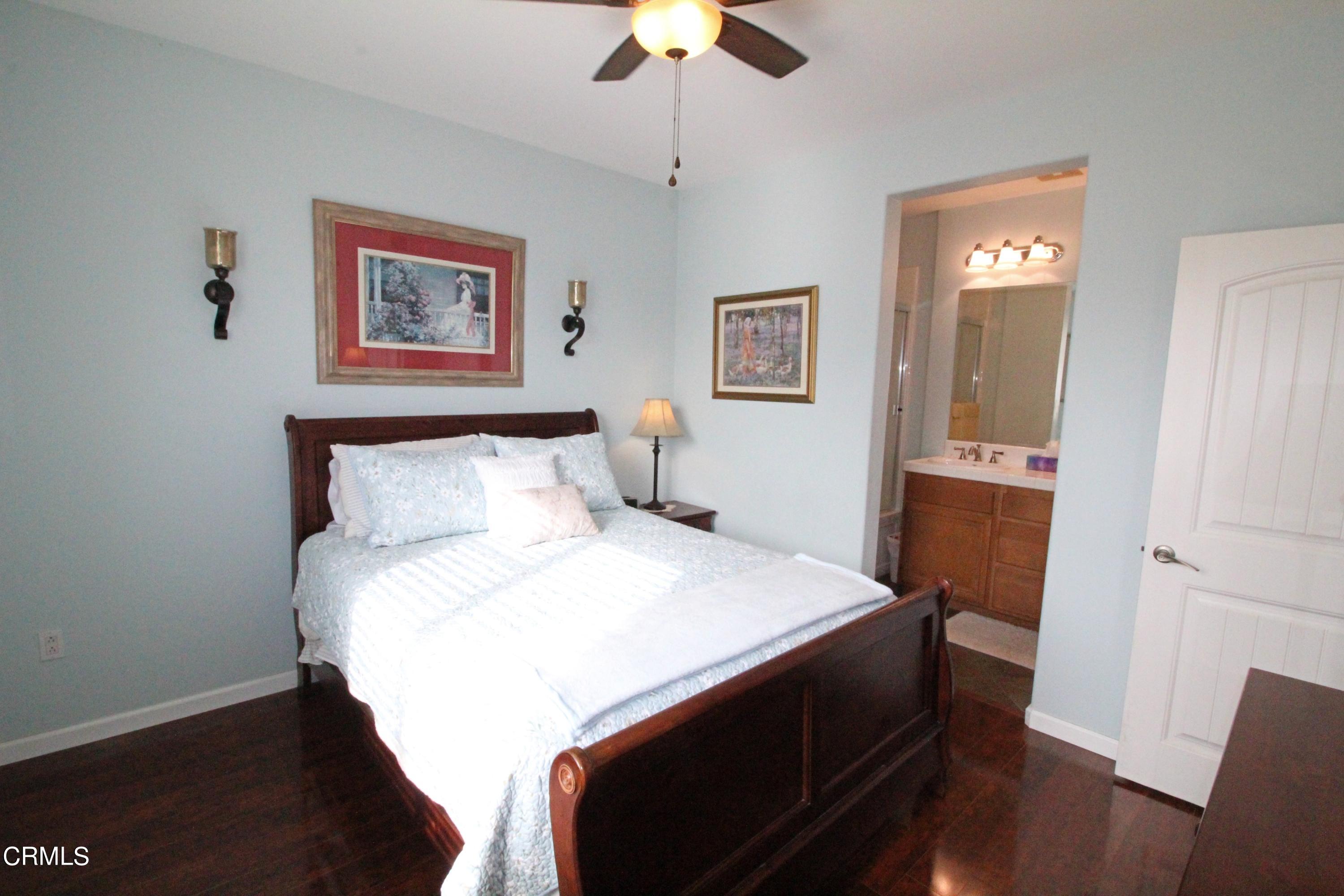 1428 Windshore Way Oxnard, CA 93035 - Photo 21 of 29 a bedroom with a bed and a chandelier