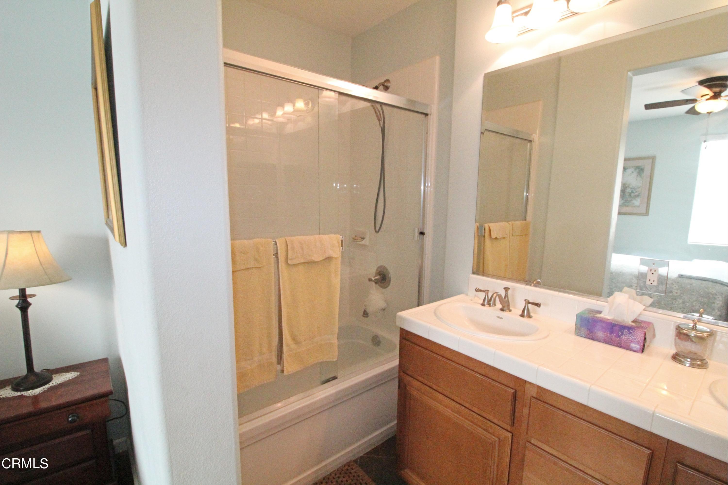 1428 Windshore Way Oxnard, CA 93035 - Photo 22 of 29 a bathroom with a tub sink vanity and mirror