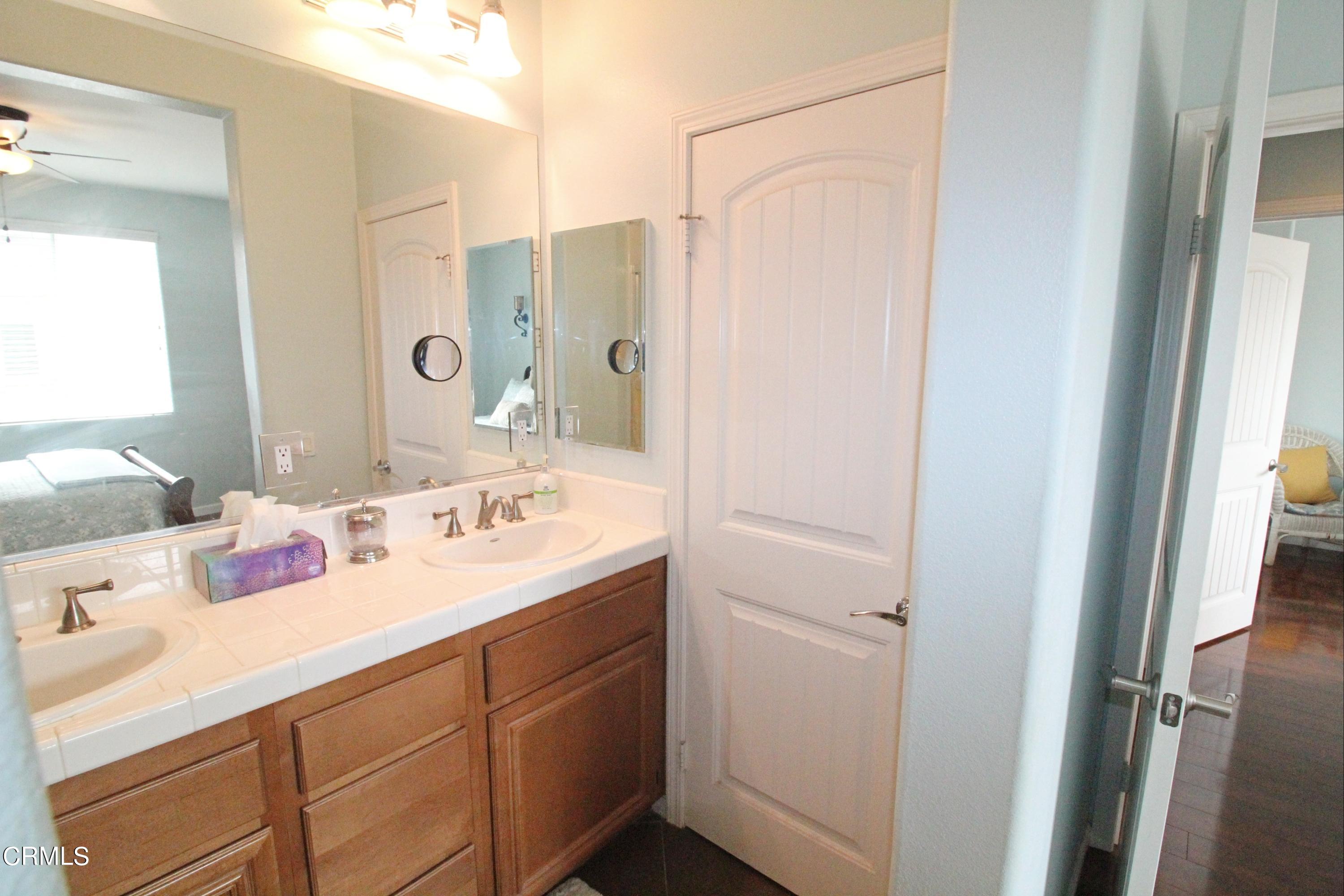 1428 Windshore Way Oxnard, CA 93035 - Photo 23 of 29 a bathroom with a sink double vanity and a mirror